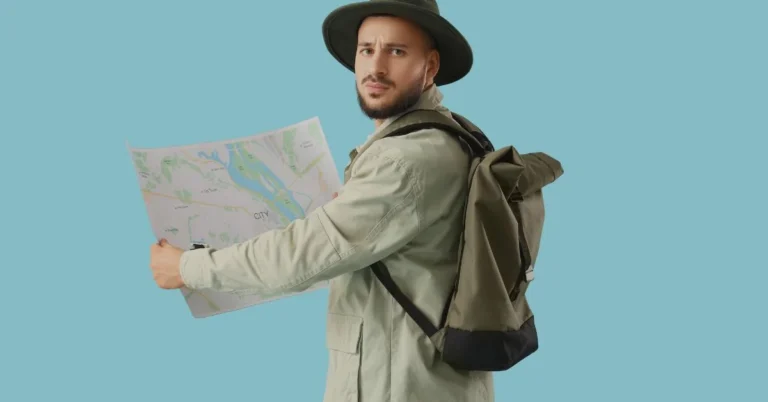 A tour guide is standing with a map in his hands.